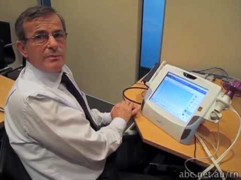 Professor Branko Celler demonstrating the home health monitoring unit (ABC Radio National)